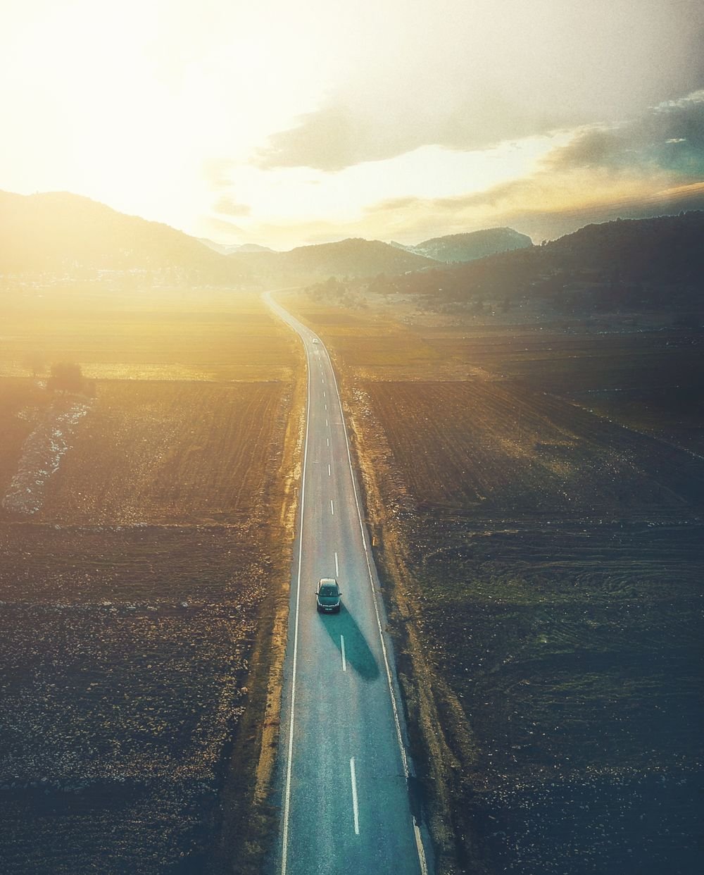Car driving on a countryside road in France
