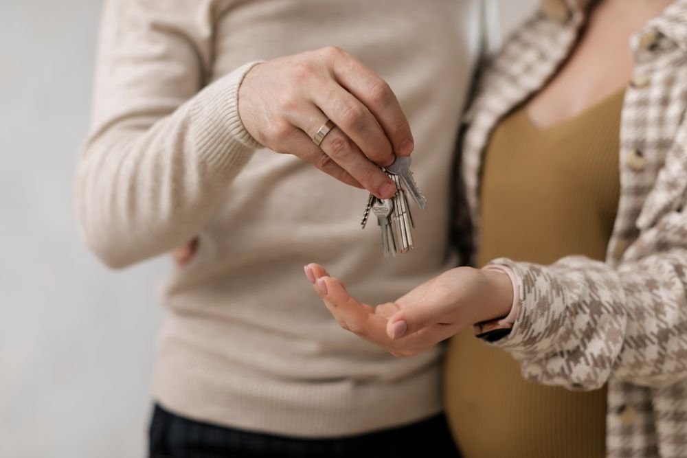 Couple holding the keys to their new French home