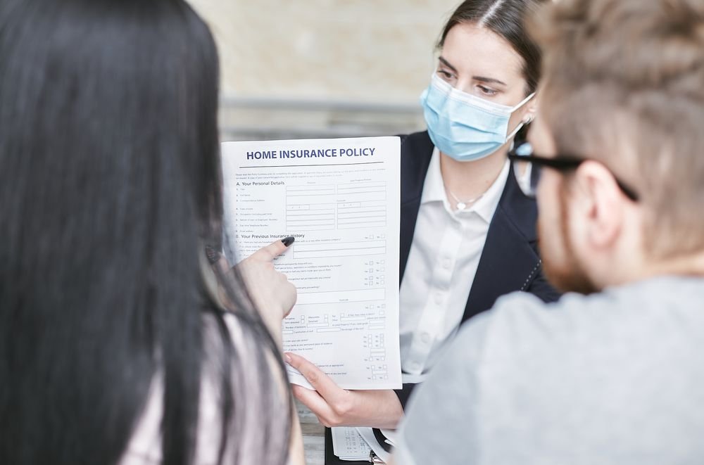 Advisor explaining a home insurance policy in English